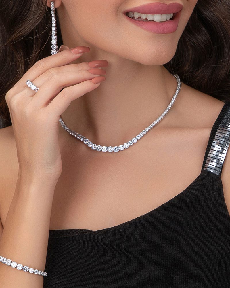Royal Tennis Elegance Ensemble – Four-Piece Jewelry Set featuring necklace, earrings, bracelet, and ring with brilliant stones.
