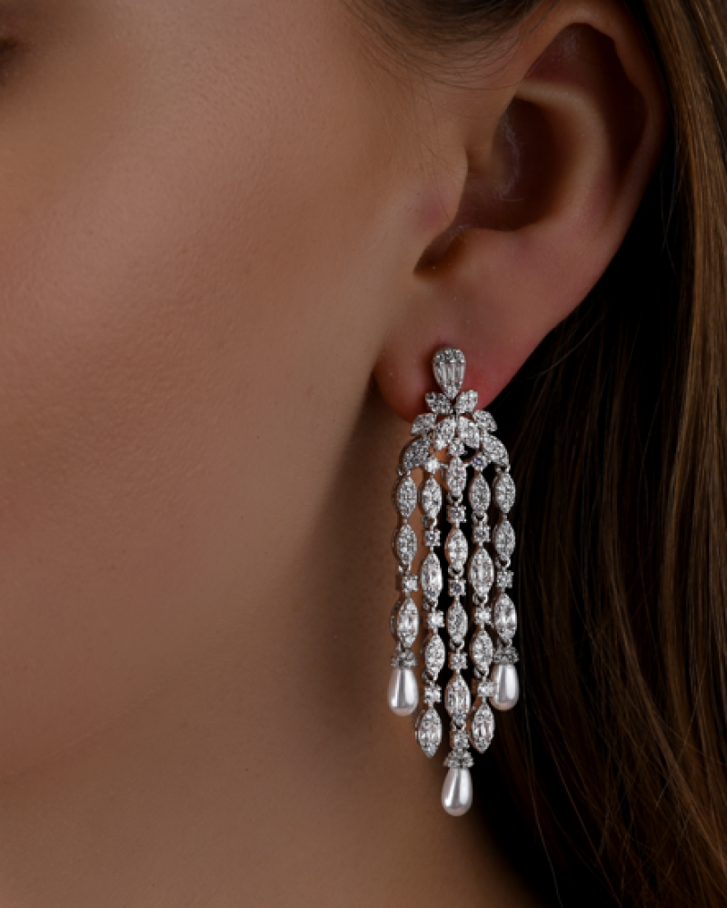 Lueur de Perle crystal chandelier earrings with cascading pearlescent drops worn by a model